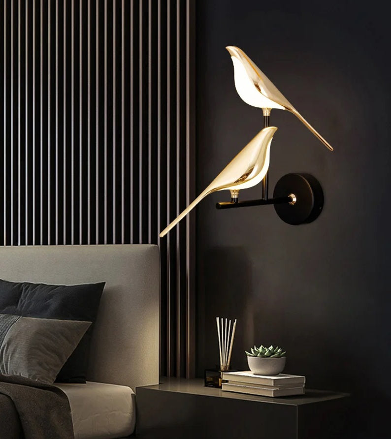 Two Bird Wall Light sconces serve as an accent piece, illuminating a modern bedroom corner.