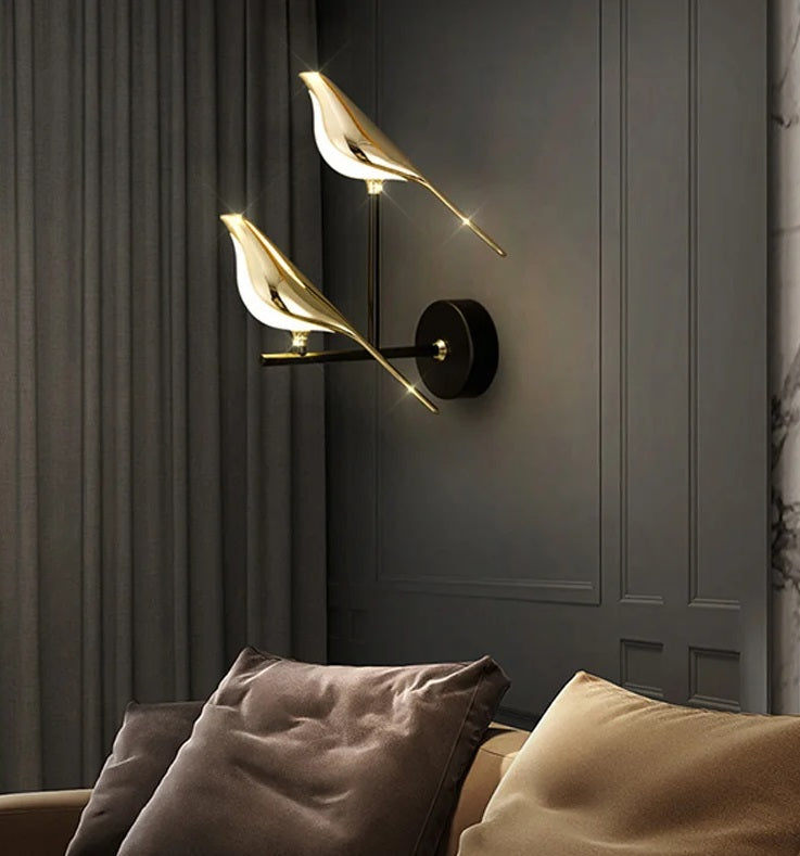 Modern Bird Wall Light with an abstract design, serving as an accent piece above a couch with cushions.