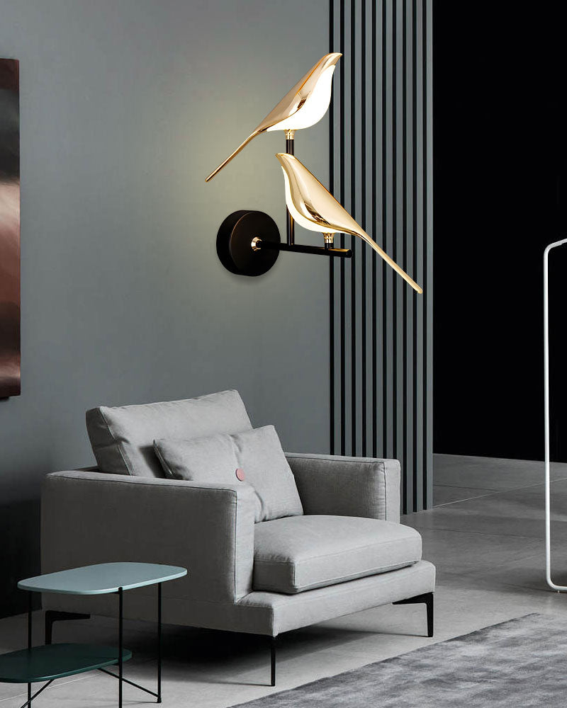 Modern living room featuring a gray armchair, bird wall light, and minimalist interior design.