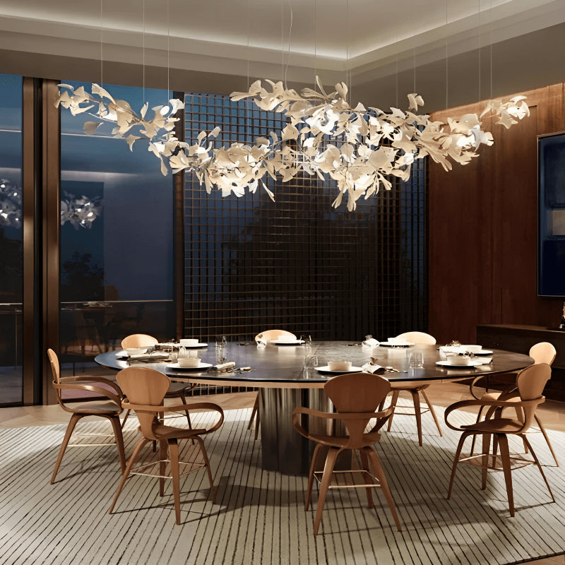 A luxurious modern dining room featuring a grand chandelier.
