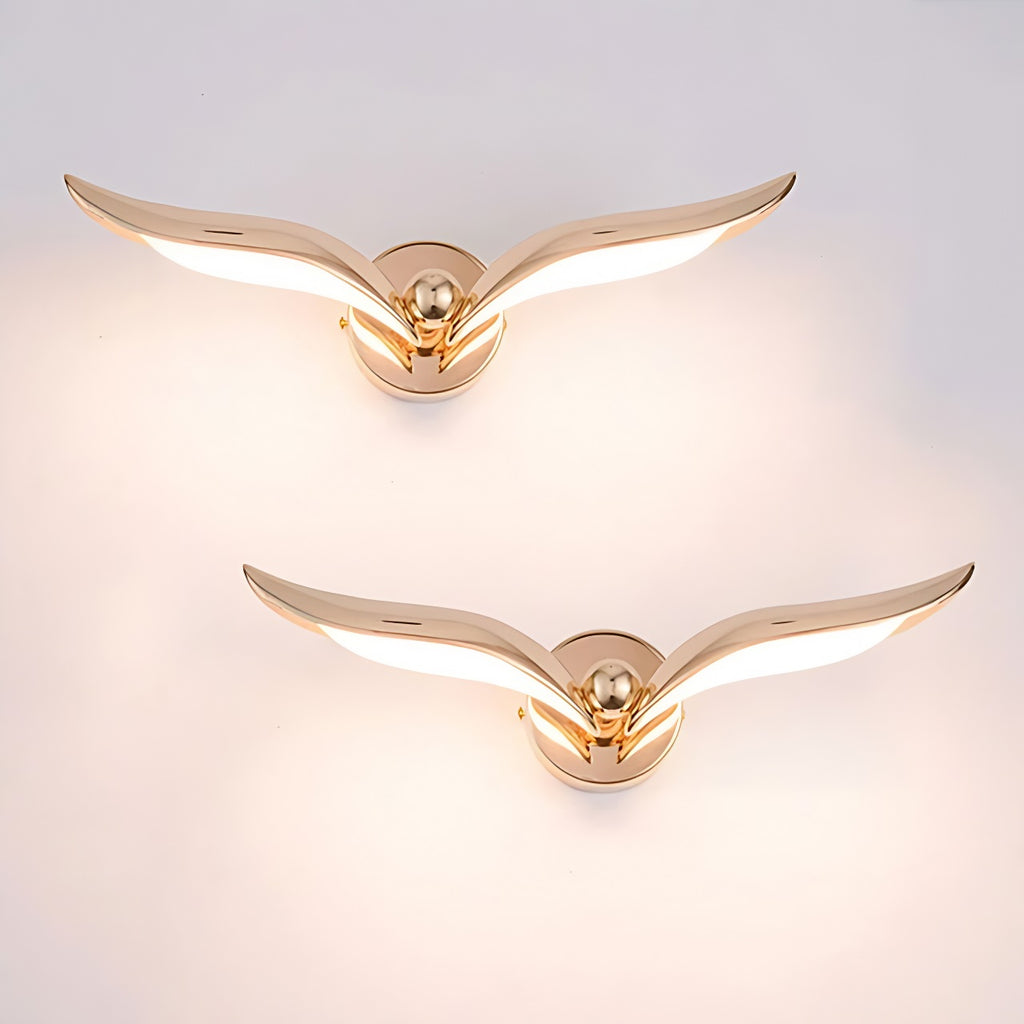 Two modern bird design gold wing shaped wall lights on a white background.