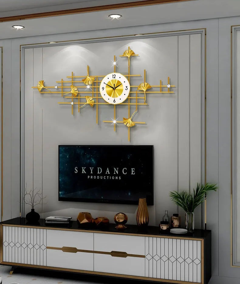 A creative interior with a gold Ginkgo Leaf Wall Clock and TV.
