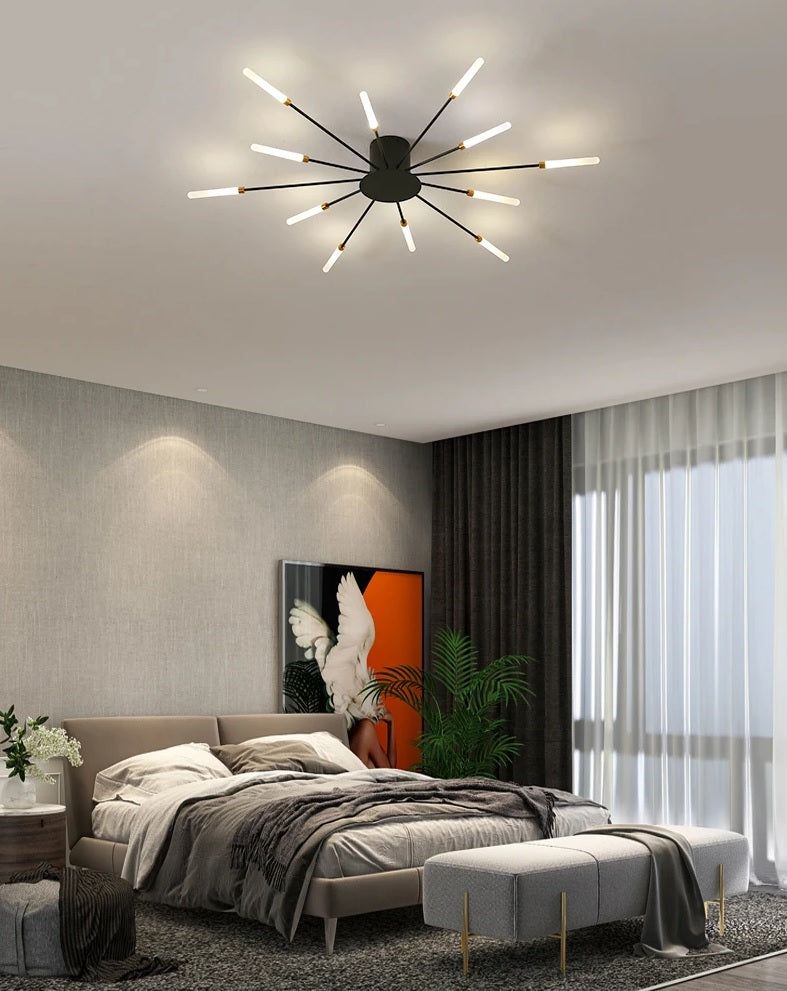 A modern bedroom with a brushed antique gold finish bed and a bedside lamp featuring a sunflower design.