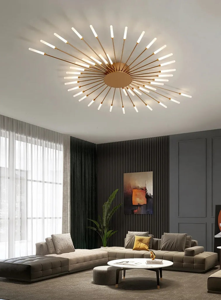 A modern living room with a Magic Wand Ceiling Light featuring a circular sunflower design, finished in brushed antique gold.