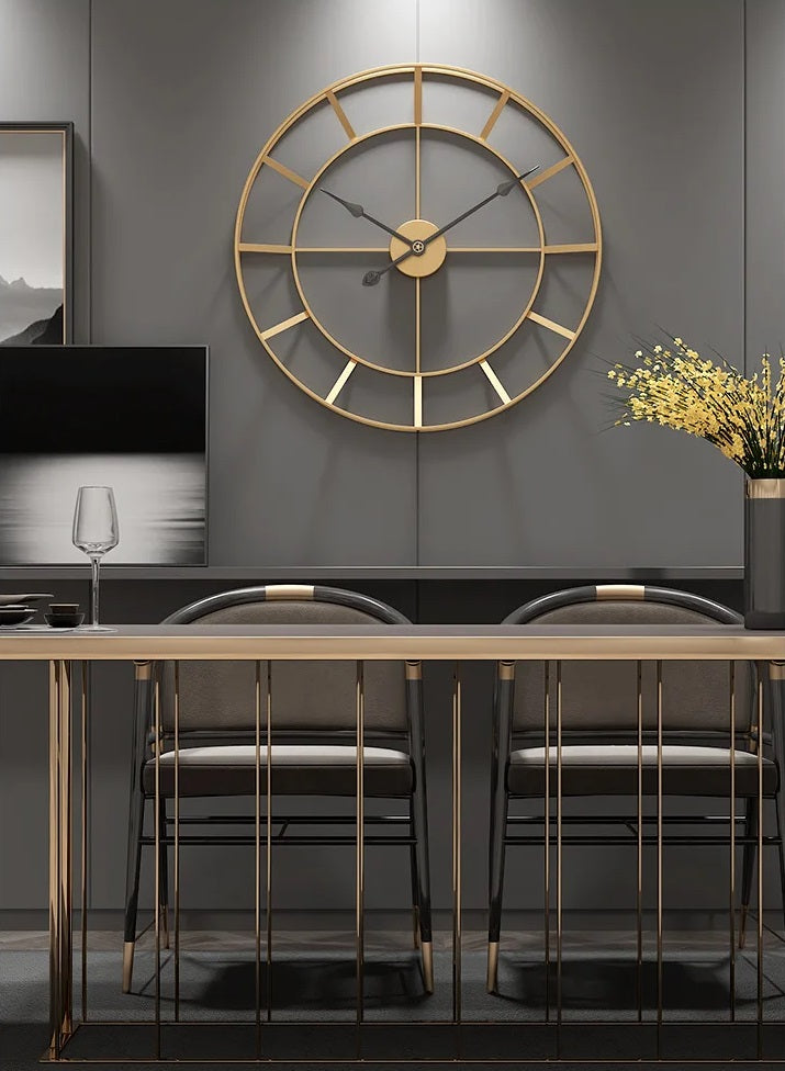 A modern home office with a geometric design wall clock, metal-framed desk, and black chairs.