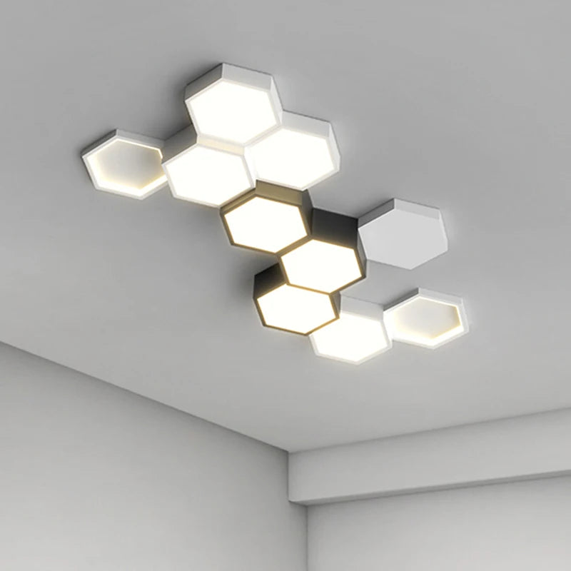 Modern adjustable hexagonal LED ceiling light fixture mounted on a white ceiling, emitting a bright glow.