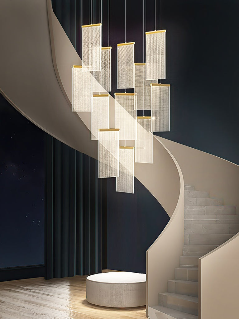 A modern villa with an elegant chandelier hanging above a staircase.