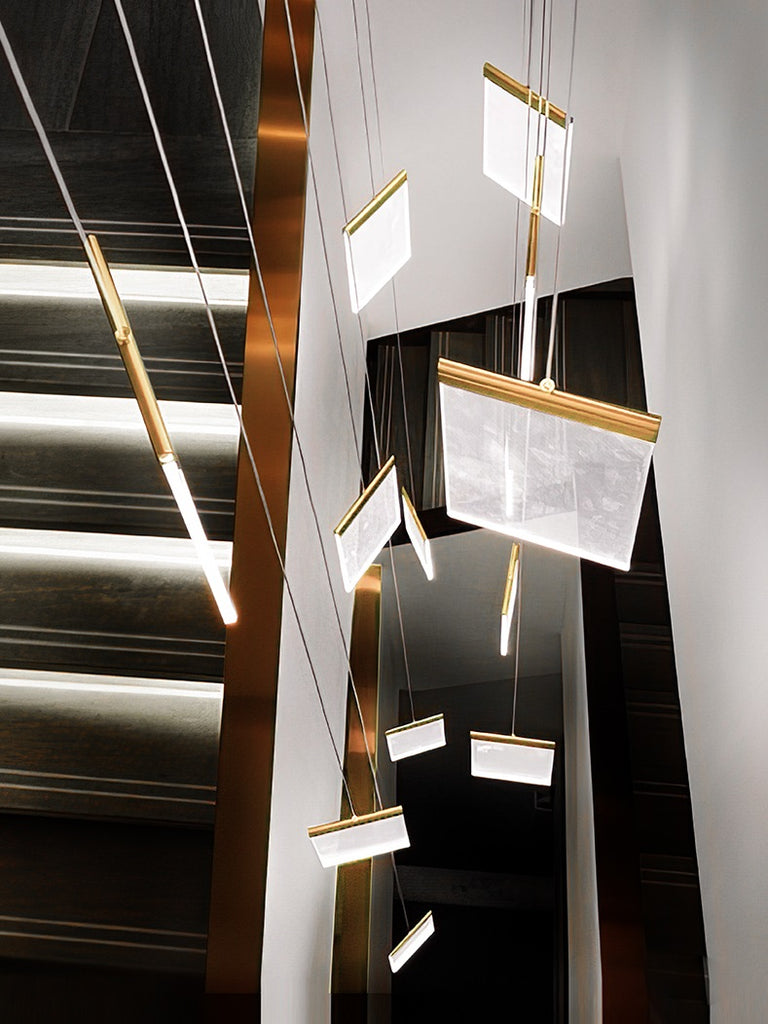 A staircase adorned with a modern villa chandelier, creating a luxurious lighting solution.