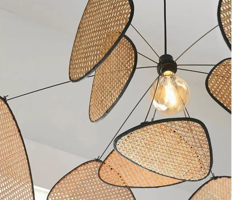 A modern wicker chandelier with a light bulb hanging from it.
