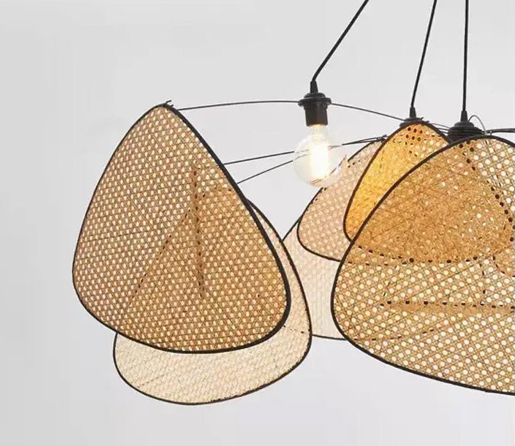 An organic meets modern look wicker chandelier with a light bulb hanging from it.
