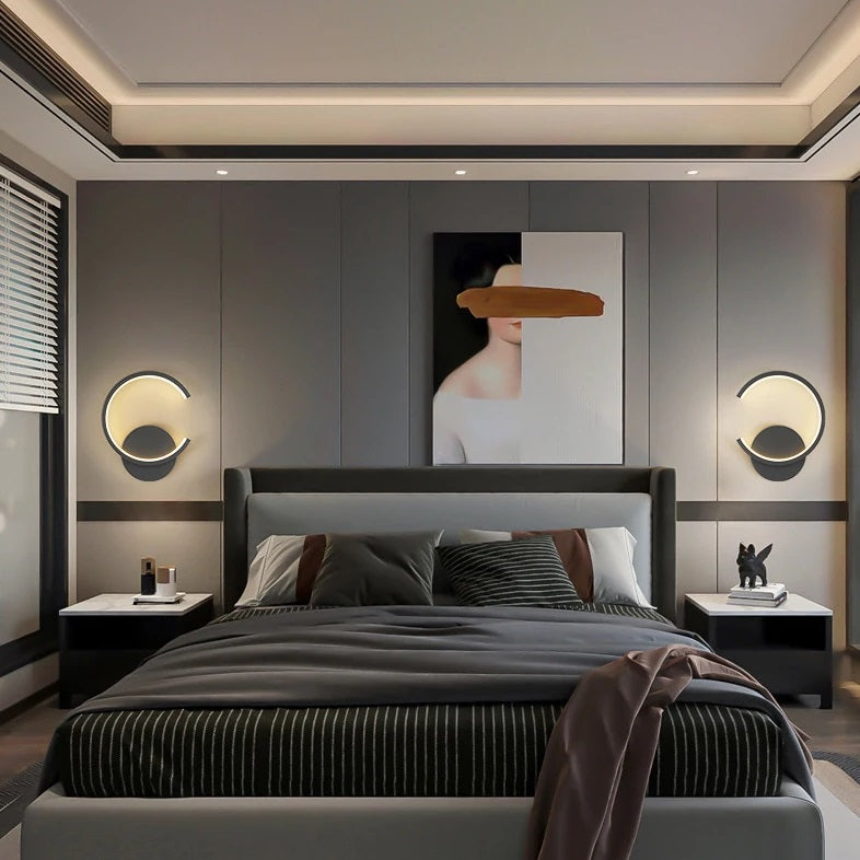 A contemporary bedroom with black and grey accents featuring a black Nordic Wall Sconce.