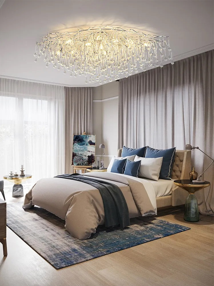A modern bedroom with a bed and an opulent crystal chandelier, exuding luxury.