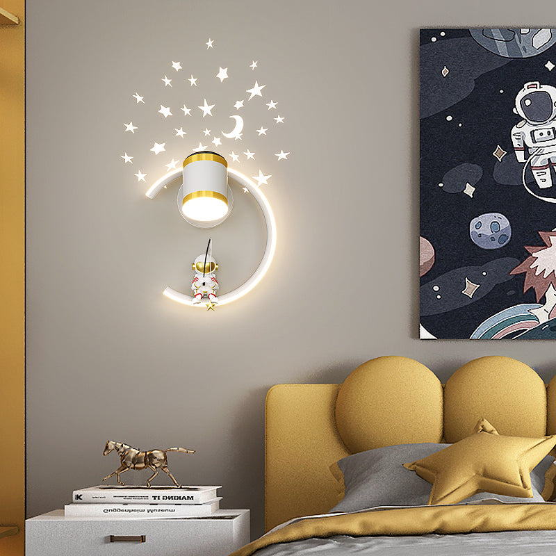 Children's bedroom with space-themed wall decor reflecting celestial wonder, including a moon-shaped astronaut wall light, perfect for aspiring astronauts.