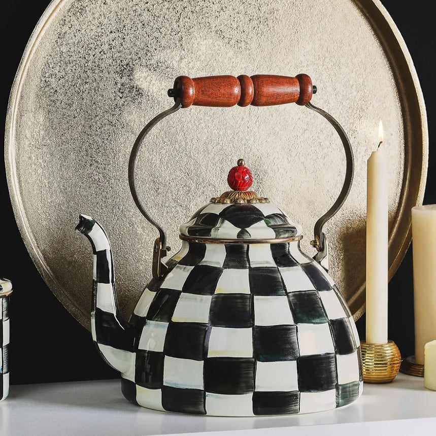 A Vintage Black and White Kettle sits on a shelf.