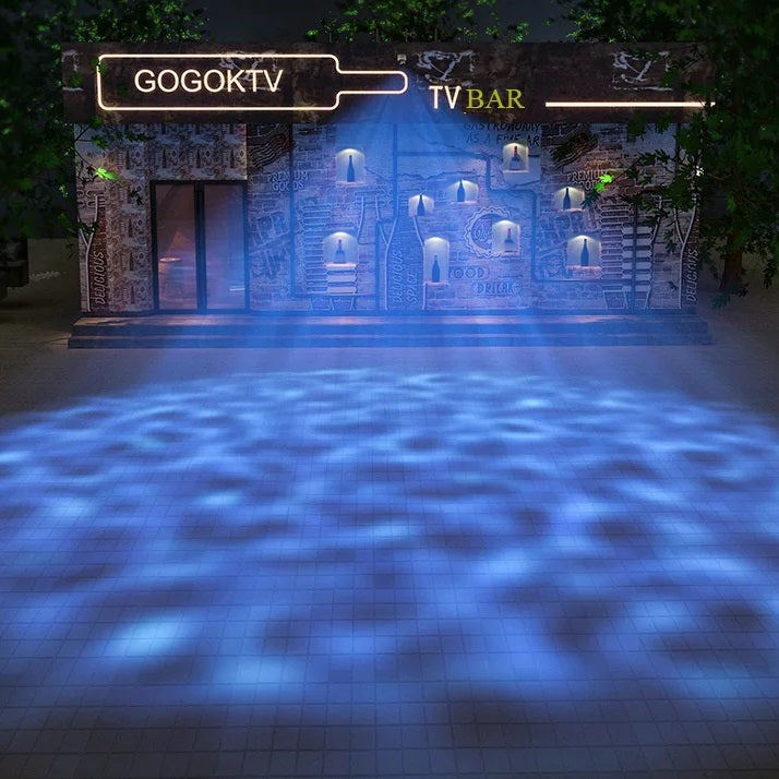 Entrance lit by blue lights, with stylish water ripple patterns projected on the ground and a luminous sign above the door.