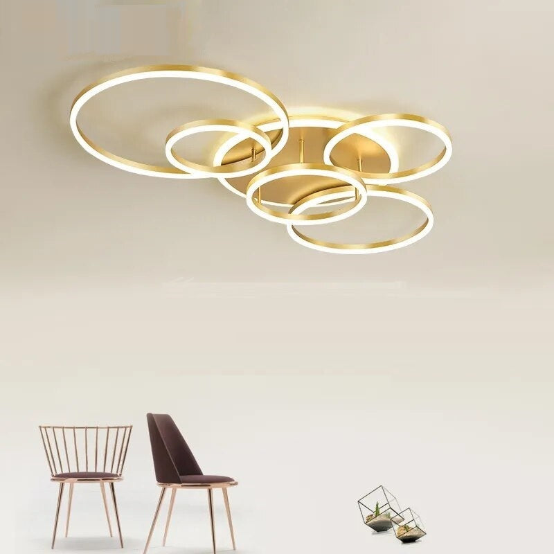 A circular brushed nickel ceiling lamp with interlocking rings.