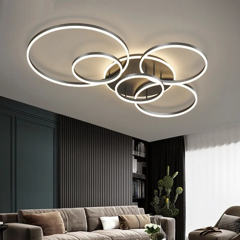 A modern living room with a brushed nickel circle ceiling lamp.