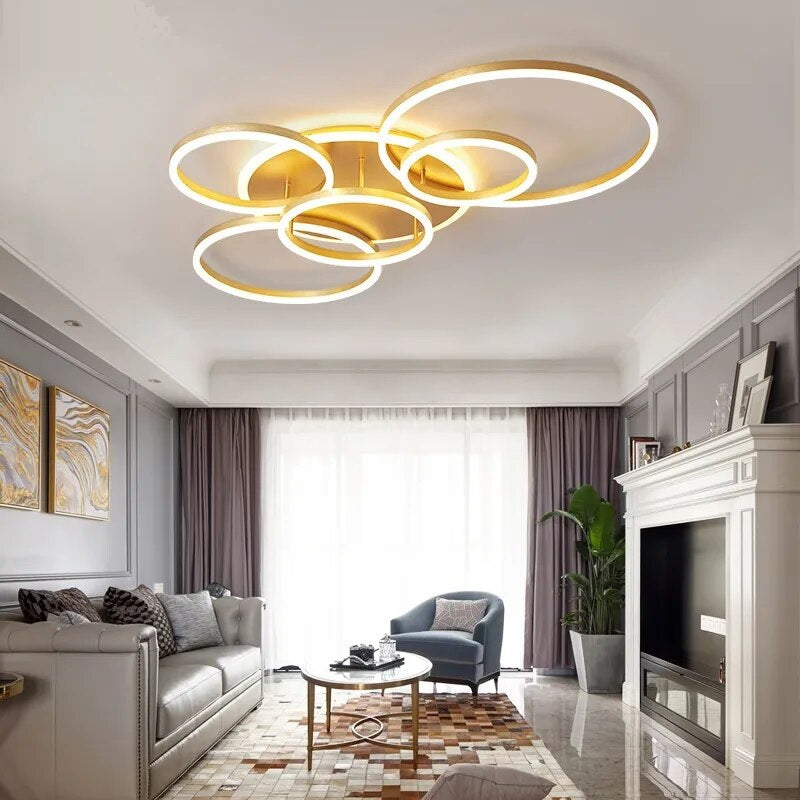 A modern living room with an interlocking rings ceiling lamp.