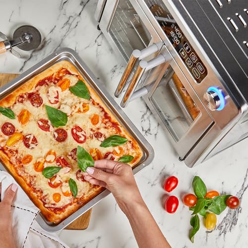 A professional chef is using an Air Fryer to cook a healthier meal by putting a pizza in the oven.