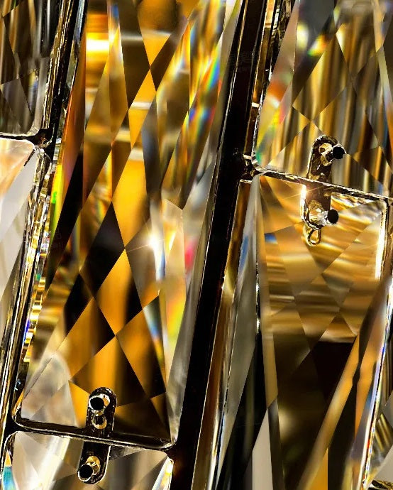 An opulent close-up image of a gold crystal chandelier in an upscale villa.