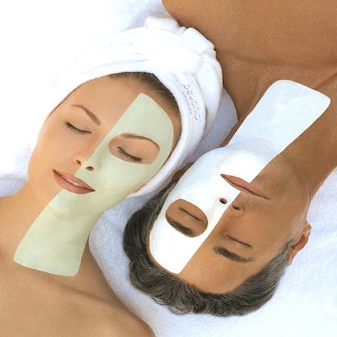 A man and woman wearing facial masks with Smart Blackhead™ Remover.