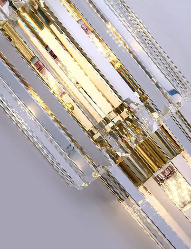 A gold and glass wall light fixture.