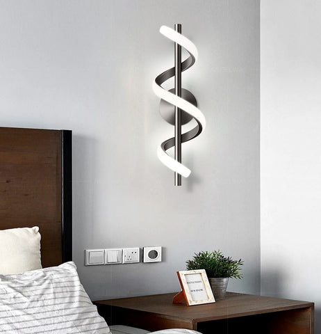 A modern bedroom with a bed and a Spiral Wall Lamp, exuding Nordic elegance and personal style.