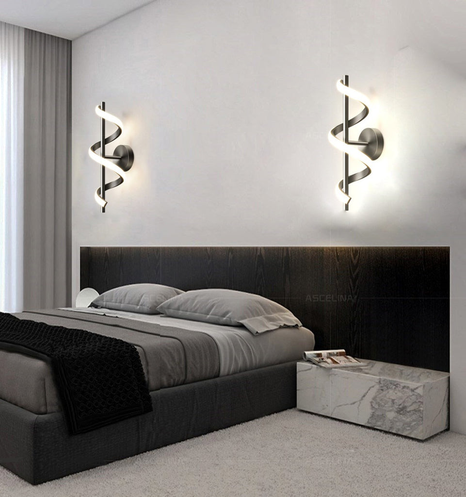 A black and white bedroom with walls adorned with Nordic elegance. The room features a comfortable bed and a sleek bedside table, illuminated by a stunning Spiral Wall Lamp.
