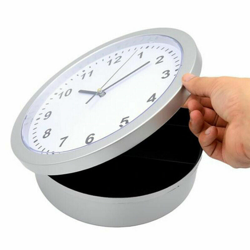 A hand opening a modern wall clock to reveal a hidden storage compartment.