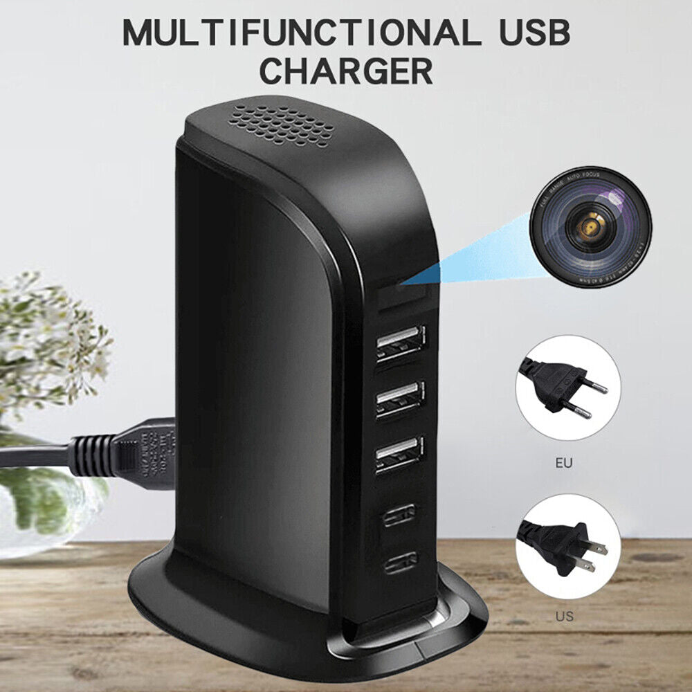 Multifunctional Spycam Charger Hub with multiple ports on a wooden desk, equipped for simultaneous charging and featuring plug adapters for EU and US.