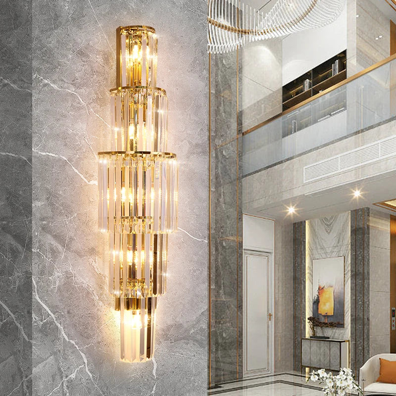 A modern living room with a marble floor and a gold chandelier featuring crystal strands.