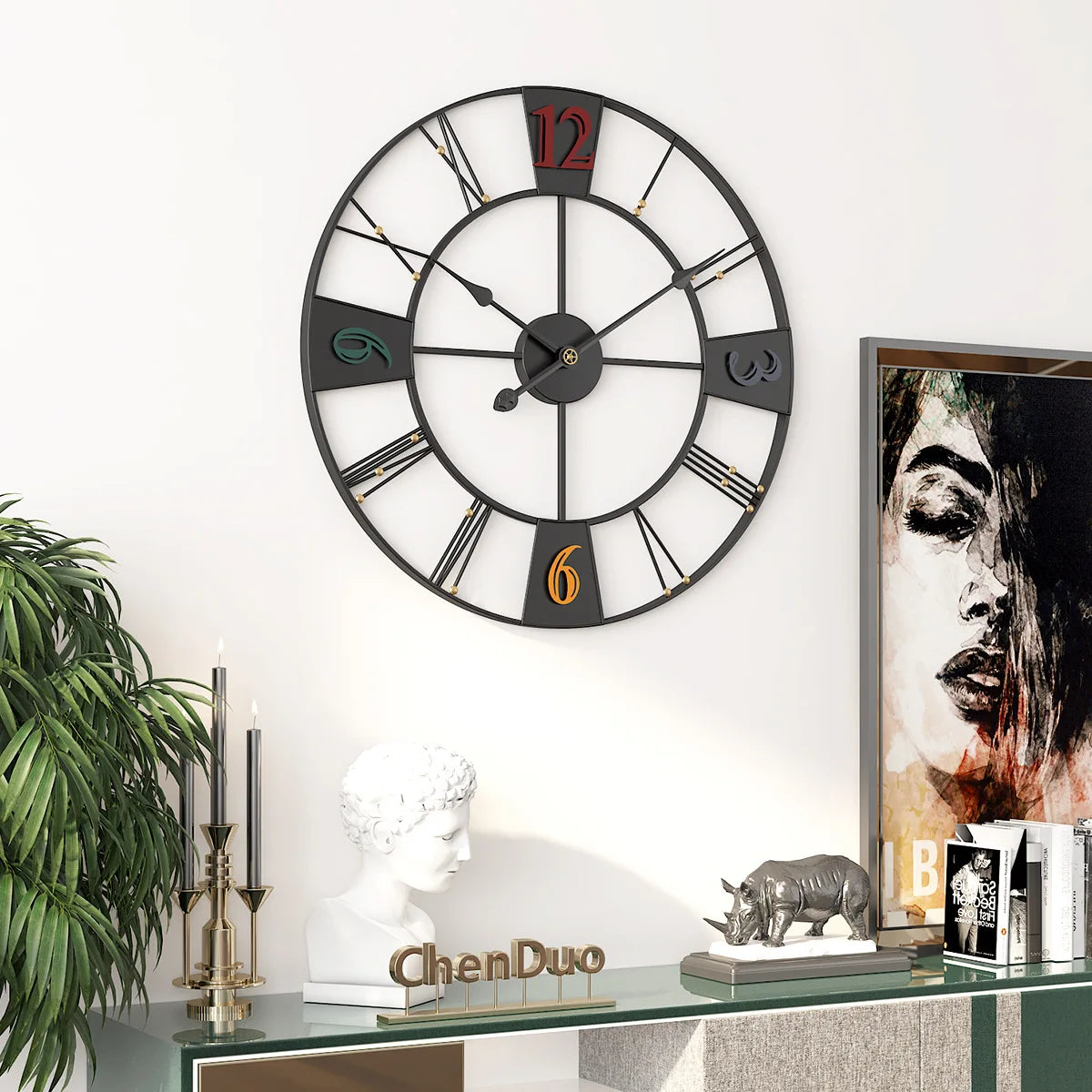 A large Roman numerals wall clock with sophistication above a modern shelf displaying decorative items and artwork.
