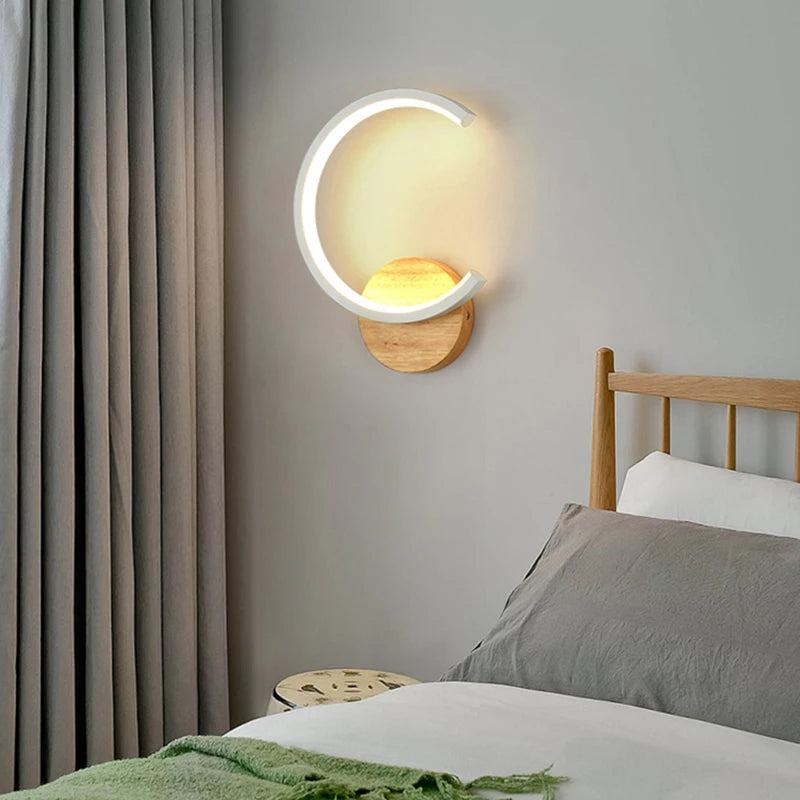 A contemporary bedroom with a bed and a white wall sconce.