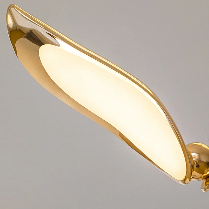 An artistic touch added to the interior with a gold wall light in a curved shape to mimic the bird wing.