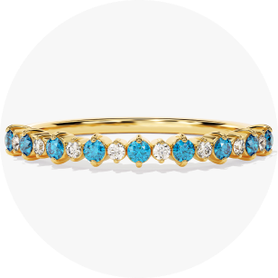 Yellow gold blue Topaz half eternity ring