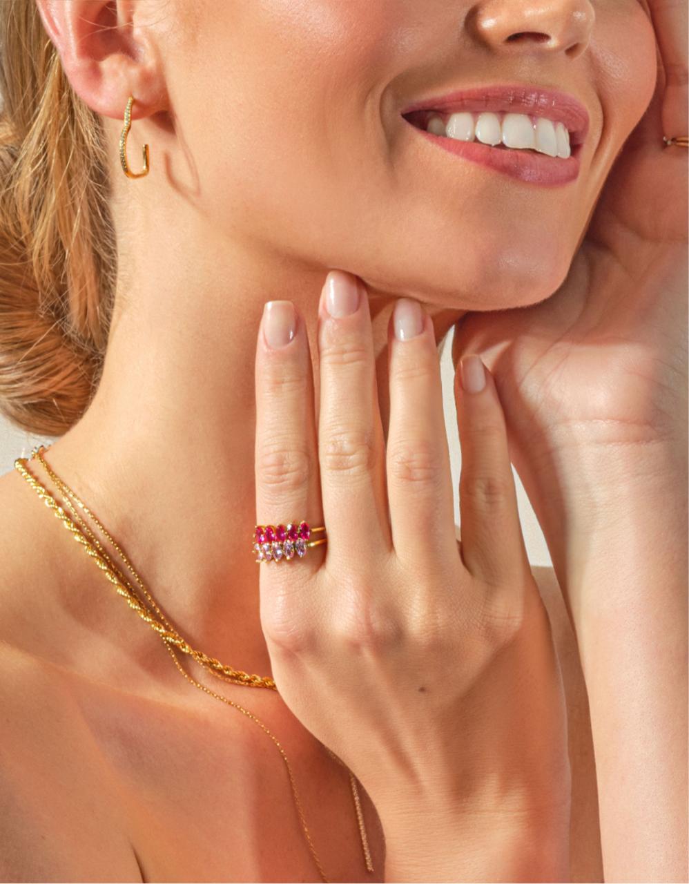 Image of a woman wearing two different white gold tennis necklaces