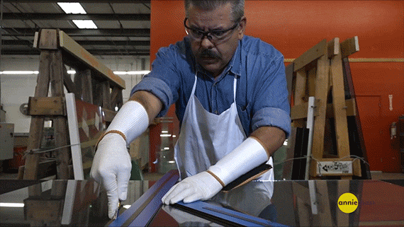 Master craftsman carefully cutting glass in Annieglass studio