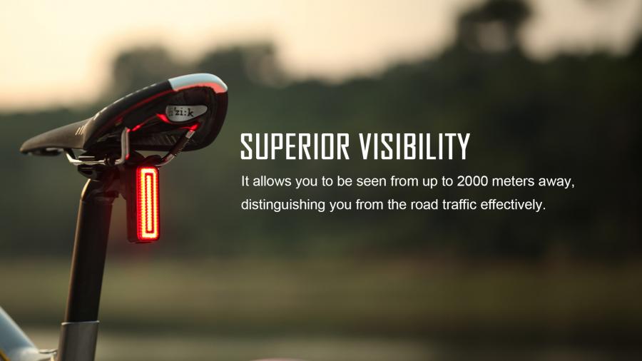 Magicshine SEEMEE 100 V2.0 Smart Rear Light mounted on a bicycle seat, glowing brightly to demonstrate superior visibility from up to 2000 meters away for cycling safety.