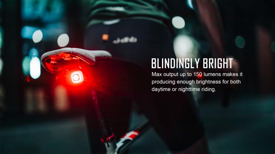 Magicshine SEEMEE 150TL V2.0 smart bicycle rear light mounted on a bike seat, glowing brightly at night