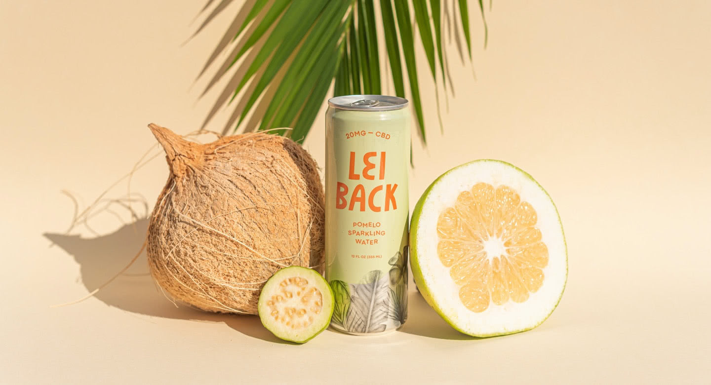 A can of Pomelo Sparkling Water with a coconut and a pomelo
