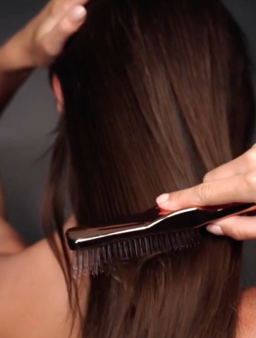 Woman using a detangling brush