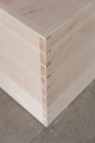 Close-up of dovetail joinery on the Maple Blanket Box by Martelo and Mo: Expert craftsmanship and attention to detail showcased in the intricate dovetail joints.
