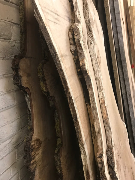 Hardwood wayne edge boards leaning against the wall in a sawmill