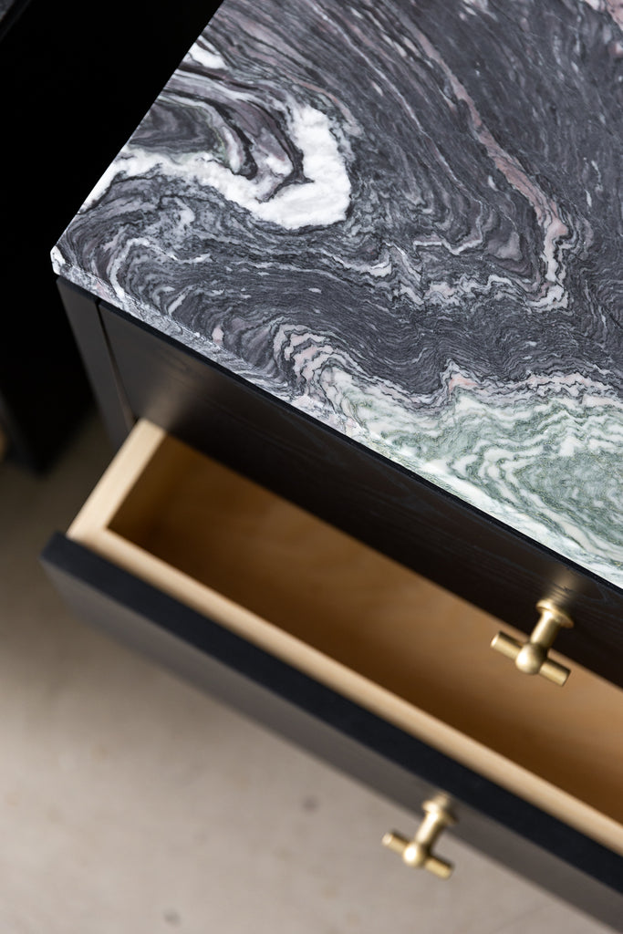 Top view of the Rosa bedside cabinet, showing marble top detail. the marble veins are dark green, white, grey and purple