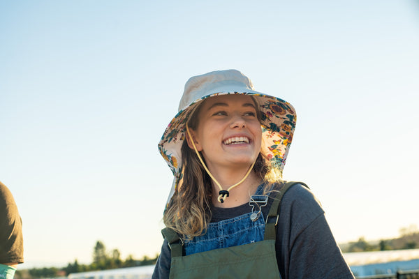 A woman enjoying the sun in her Farmers Defense UPF 50+ sun protection apparel.