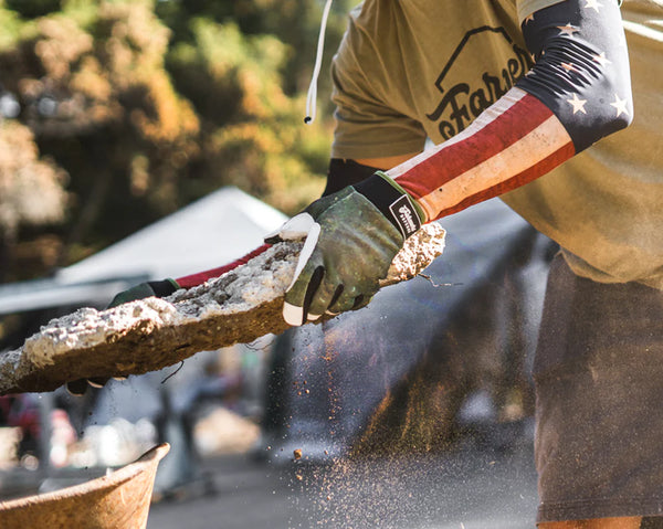 A man doing hard physical labor wearing his UPF 50+ protective sleeves.