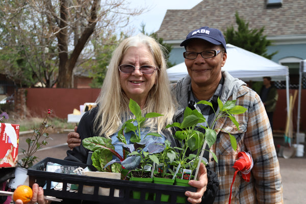 A couple purchasing plants at the DUG spring plant sale event.
