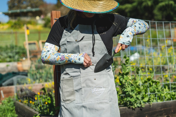 The bee sleeves in action as a gardener puts his shovel away in his Farmers Defense apron.