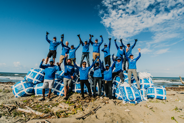 A crew of cleaners on a beach.