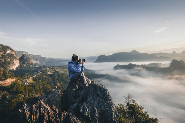 A photographer on a mountain top.